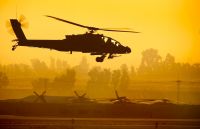 An AH-64 Apache attack helicopter hovers before takeoff from Balad Air Base, Iraq, Jan. 3, 2008. A 30-mm automatic Boeing M230 chain gun is located under the fuselage, which provides a rate of fire of 625 rounds per minute.