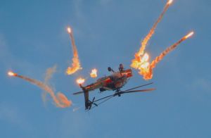 Boeing AH-64D Apache c/n DN017 with tailnumber Q-17 of the Royal Netherlands Air Force with the 2011 livery of the Apache Solo Display fires flares during the Open Days of the Dutch Air Force on 17 September 2011 over Leeuwarden air base in The Netherlands (EHLE).